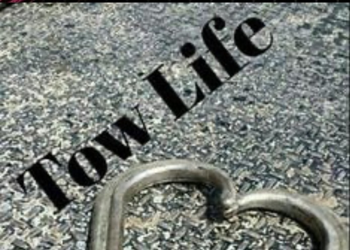 Tow Life keychain on pavement